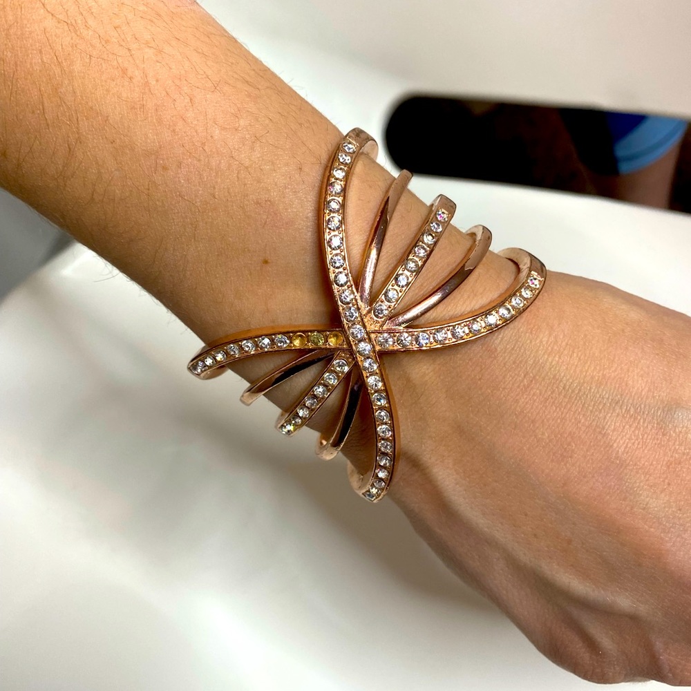 Rose gold colored butterfly style bracelet with rhinestones